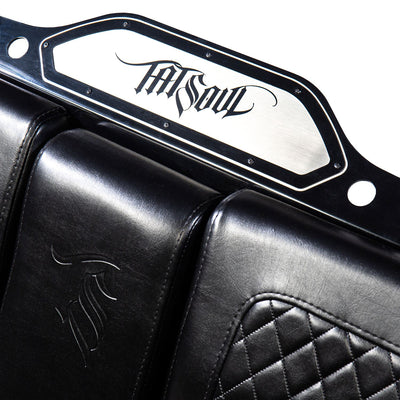 A close-up view of the TATSoul logo on the metal frame of the Comfort Before Pain Waiting Room Bench. This decal can be customized.